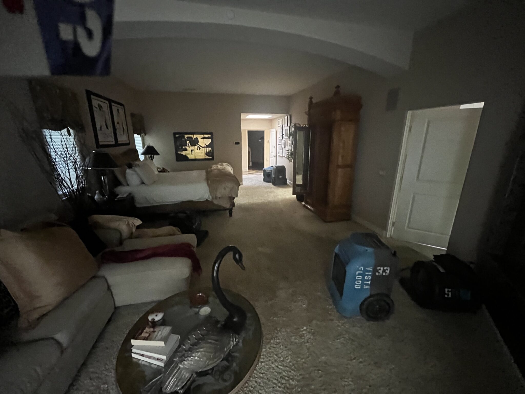 Professional structural drying equipment from San Diego Flood Services (SDFS) extracting moisture in a San Marcos master bedroom.